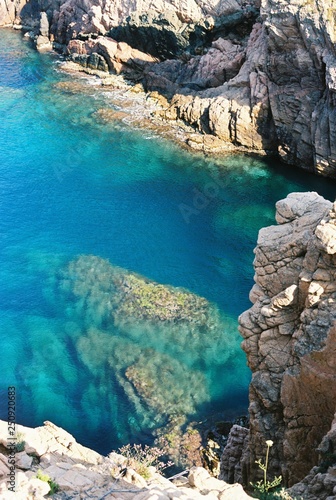 Transparent blue sea between the rocks on Spanish coat on a sunny day