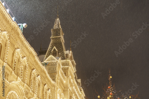 Bright illuminated facade of the GUM (Central Department store) in Moscow. Lighting of the Red Square during blizzard in Februay. photo