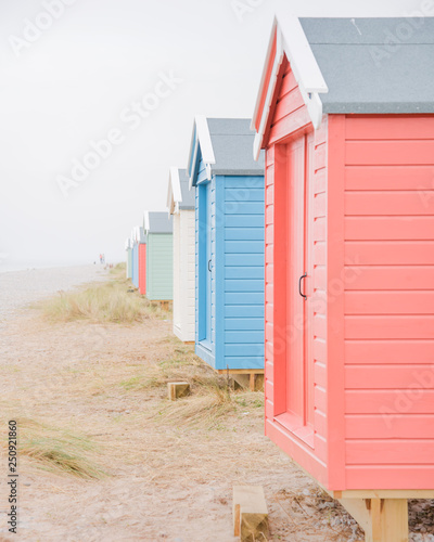 Findhorn, Scotland - July 2016: Colourful beach huts along the coast at Findhorn Bay in Northern Scotland among the sand dunes