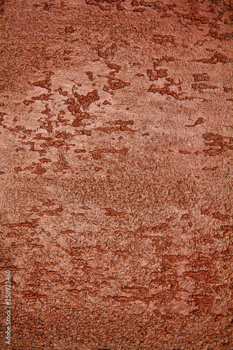 old textured wall with decorative plaster. stylized bronze, copper, metal.