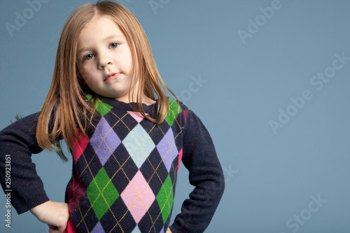 Portrait of girl with blond hair standing indoors photo