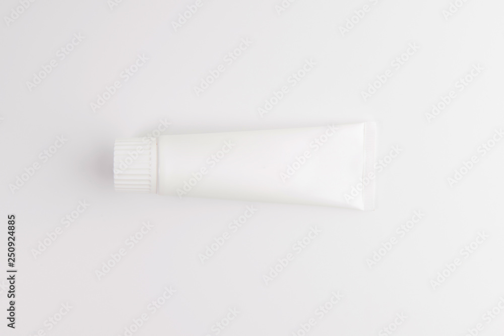 Blank white tube of toothpaste, cream or gel standing on white background. Branding mockup Blank white tube of toothpaste, cream or gel standing on white background. Branding mockup
