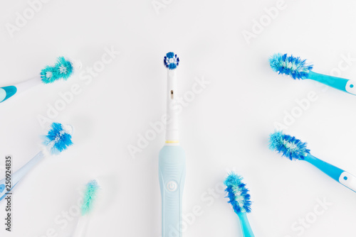 Manual regular Toothbrush Against Modern Electric Toothbrush. Isolated on White Background. Manual used tuthbrushes background