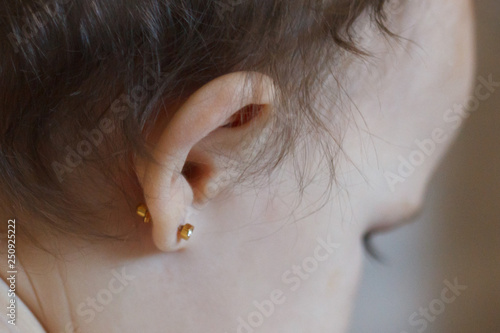 ear piercing for small children, one year old child photo