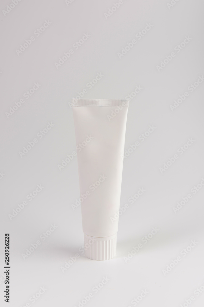 Blank white tube of toothpaste, cream or gel standing on white background. Branding mockup Blank white tube of toothpaste, cream or gel standing on white background. Branding mockup