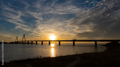highway bridge over water at sunset 