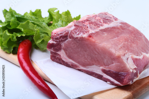 Raw pork chops with herbs and spices on cutting board. Ready for cooking.