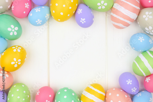 Wall Mural Colorful pastel Easter Egg frame against a white wood background