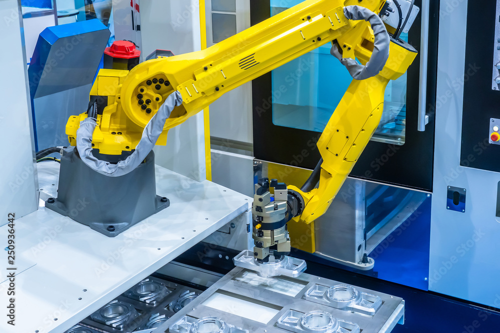 The robot arm. Manipulator puts the parts in the machine..Robotic  technology. Automation of production. Industrial work of the robot  manipulator. Robots in production. foto de Stock | Adobe Stock