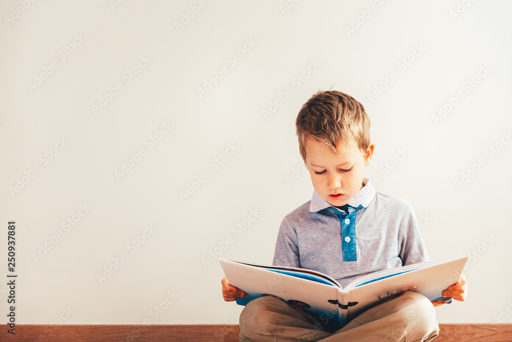 Portrait of boy interested in reading a book. Portrait of boy interested in reading a book.