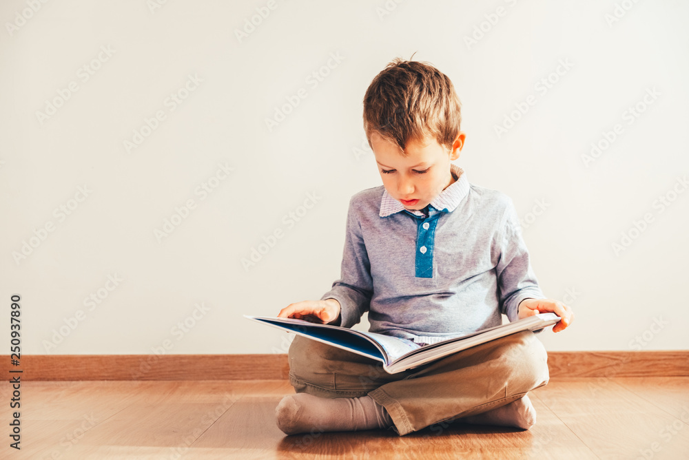 Portrait of boy interested in reading a book. Portrait of boy interested in reading a book.