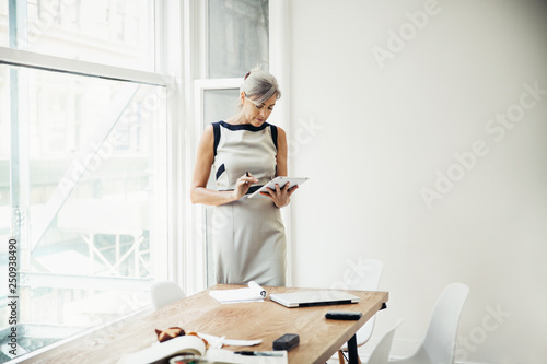 Businesswoman using digital tablet in office  photo