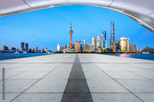Empty square floor with panoramic city skyline in shanghai at night,China