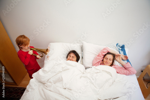 Son ( 6-7 ) waking up parents with bugle 