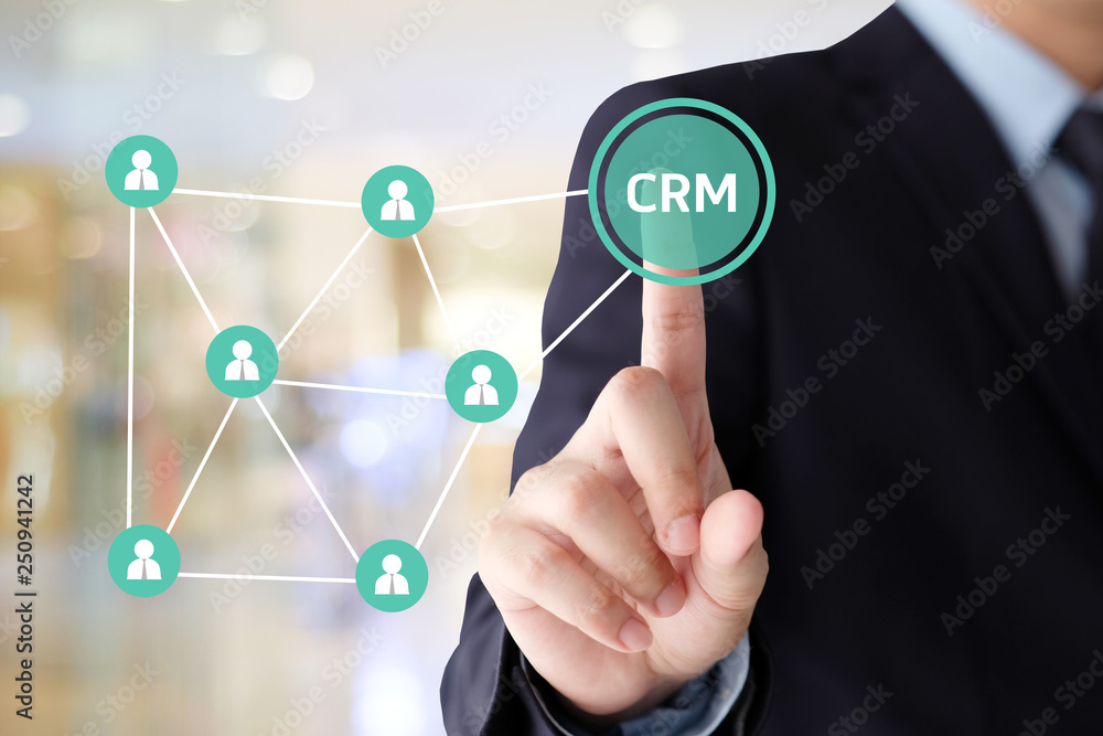 Businessman hand touch CRM, Customer Relationship Management, icon over blur background, success in business concept Businessman hand touch CRM, Customer Relationship Management, icon over blur background, success in business concept