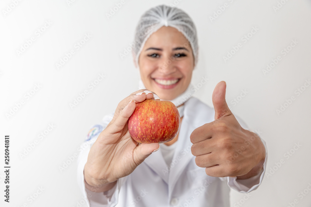 Young woman nutritionist holding an apple fruit. Doctor woman. Young woman nutritionist holding an apple fruit. Doctor woman.
