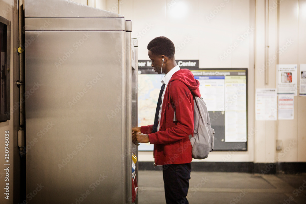Teenage boy (14-15) choosing snack from vending machine Teenage boy (14-15) choosing snack from vending machine