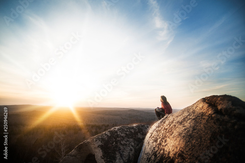 Young woman sitting on boulder  photo