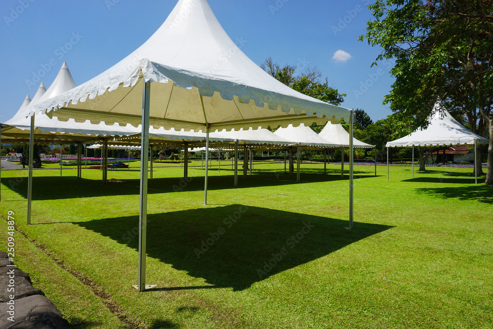 white tent with green grass on the garden park with shed - photo indonesia bogor - obrazy, fototapety, plakaty 