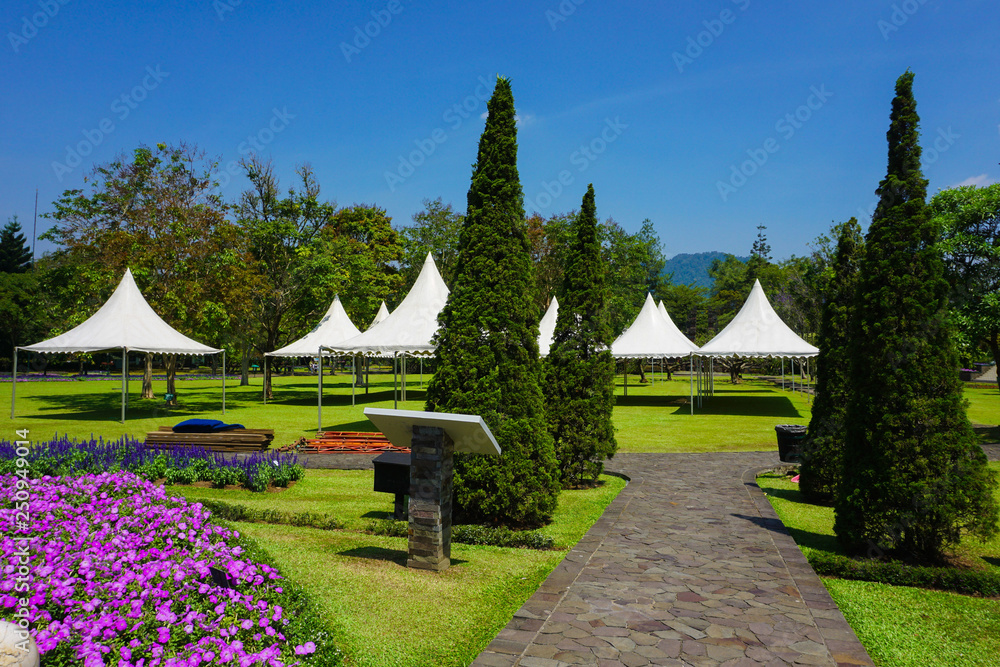 pathway from stone with going to white tent on the park - photo indonesia bogor