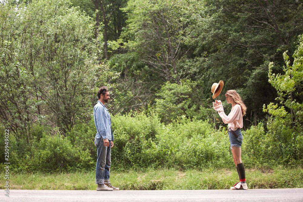 Side-view of couple standing on road Side-view of couple standing on road