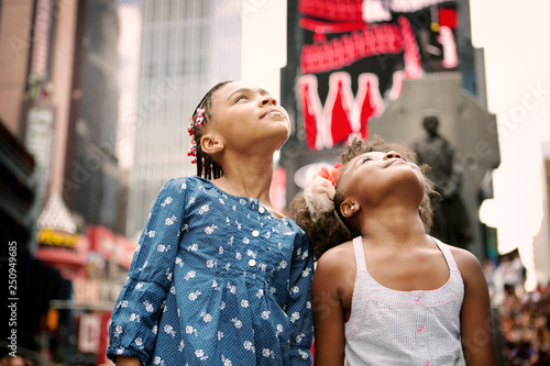 Portrait of two girls (4-5, 6-7) looking up 
