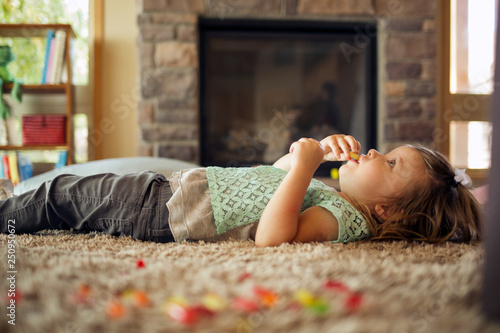Little girl lying on carpet in living room  photo