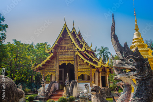 Lanna style Buddhist church at Wat Phra Singh(Temple of the Lion Buddha) with blue sky background. Wat Phra Singh is an important Buddhist monastery and temple on the west side of Chiang Mai, Thailand © kampwit