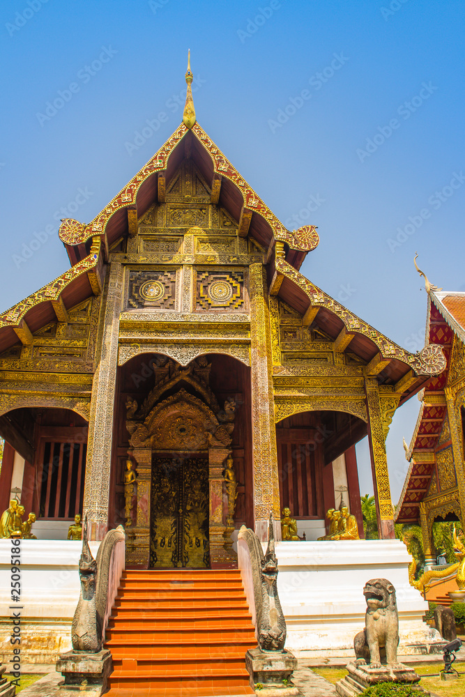 Lanna style Buddhist church at Wat Phra Singh(Temple of the Lion Buddha) with blue sky background. Wat Phra Singh is an important Buddhist monastery and temple on the west side of Chiang Mai, Thailand