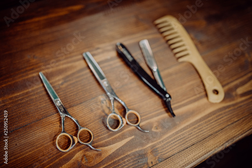 Vintage tools of barber shop on a wooden background