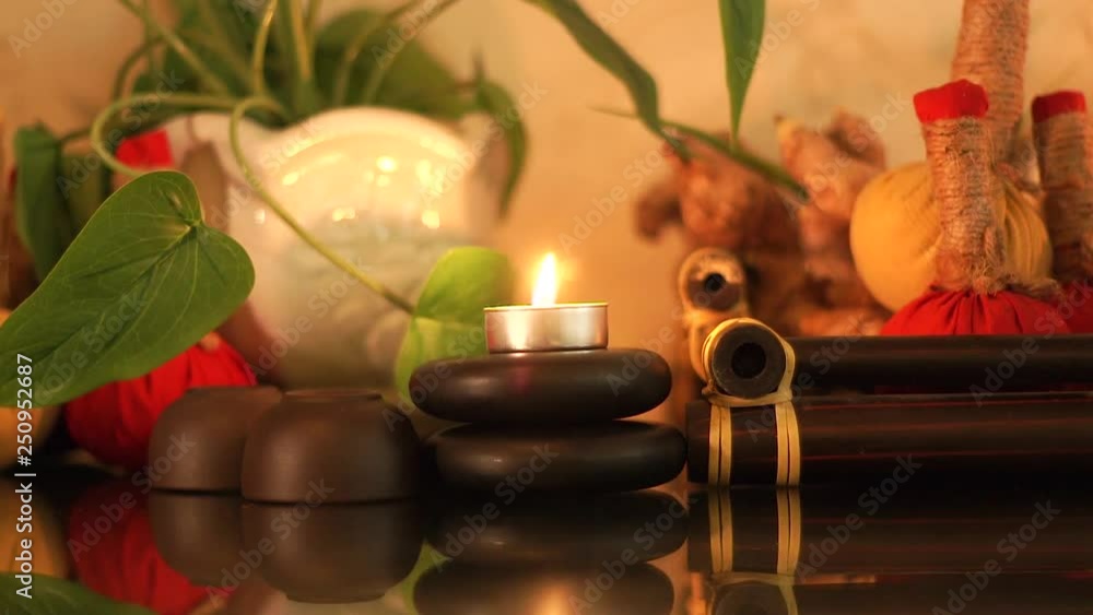Spa massage background. Decoration with candles, stones and herbs for aromatherapy in beauty spa. Accessories for massage and relaxation in luxury resort. Alternative medicine and body therapy Spa massage background. Decoration with candles, stones and herbs for aromatherapy in beauty spa. Accessories for massage and relaxation in luxury resort. Alternative medicine and body therapy