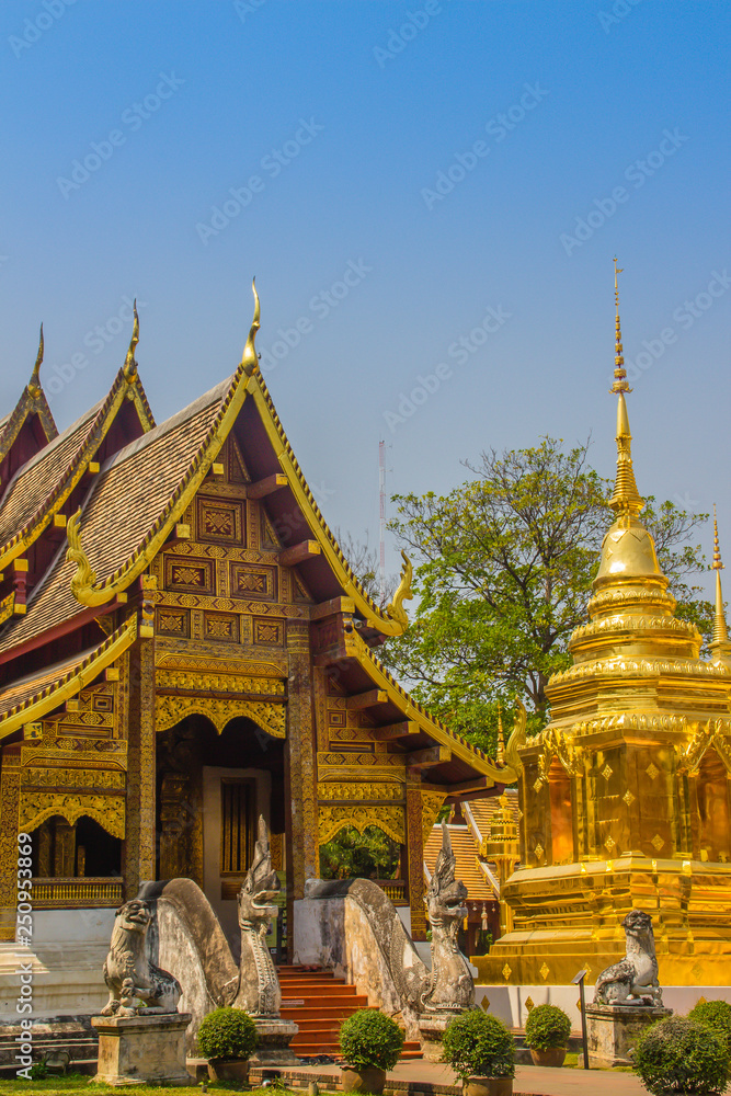 Lanna style Buddhist church at Wat Phra Singh(Temple of the Lion Buddha) with blue sky background. Wat Phra Singh is an important Buddhist monastery and temple on the west side of Chiang Mai, Thailand