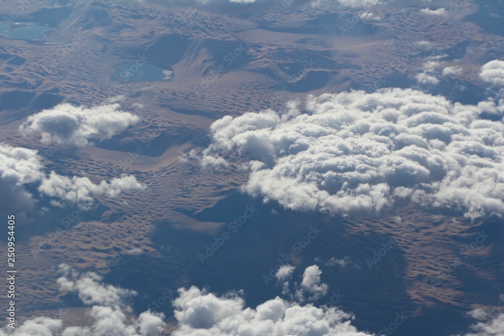 Aerial View of Desert Dunes and Altocumulus Clouds from Plane Over Central Asia 