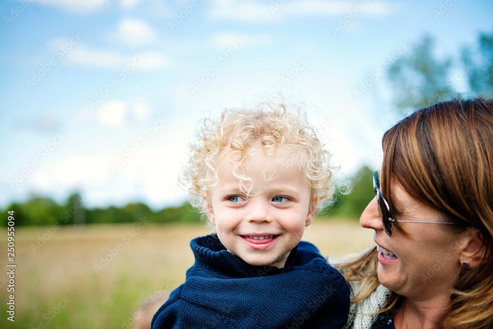 Portrait of happy mother and daughter (2-3) in meadow Portrait of happy mother and daughter (2-3) in meadow