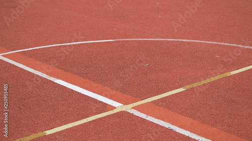 An empty of outdoor colorful basketball court in hongkong. Pole aerial image including of pavement crack, red key, yellow lines. health concept
