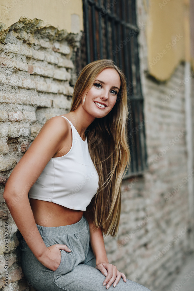 Fototapeta premium Blond girl wearing casual clothes in the street. 