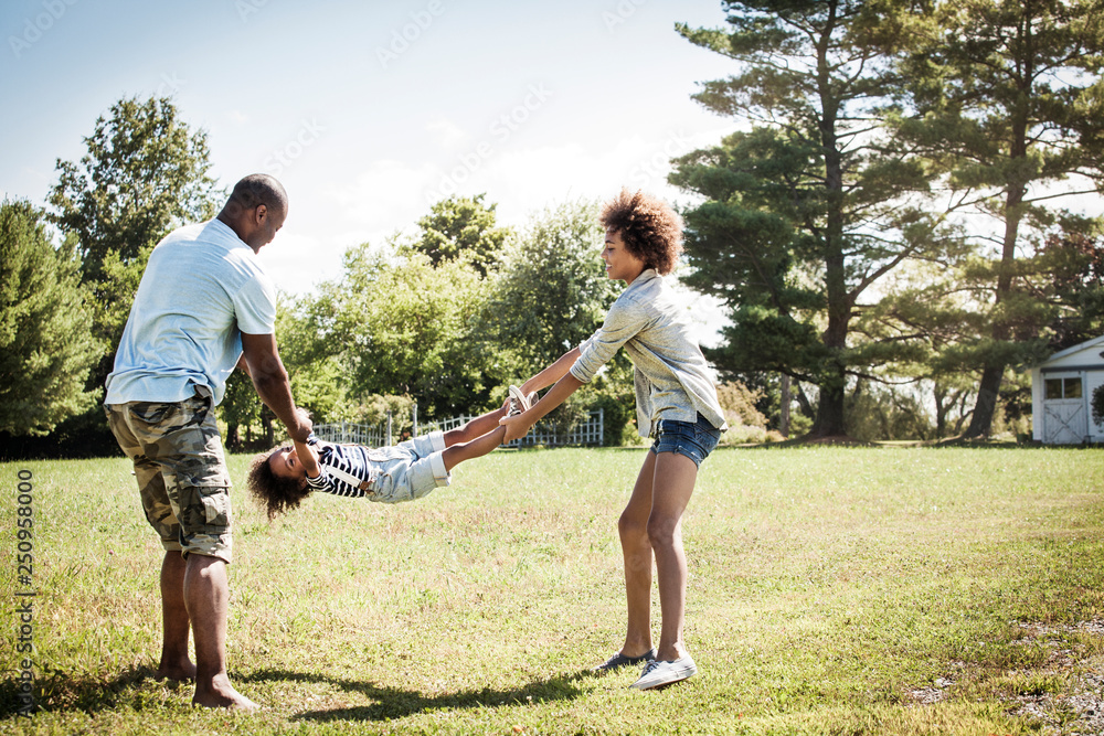 Girls (2-3, 14-15) playing with dad in backyard 