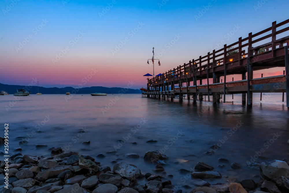 Scenic view onto Lake Tahoe at sunset by an old wooden pier in Carnelian Bay, Califronia USA