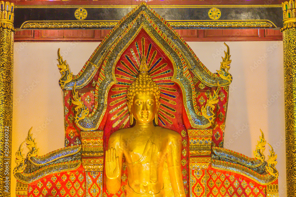 Beautiful large standing golden Buddha image with ceiling interior decoration, named Phra Chao Attarot at Wat Chedi Luang (temple of the big royal stupa), located in Chiang Mai, Thailand.