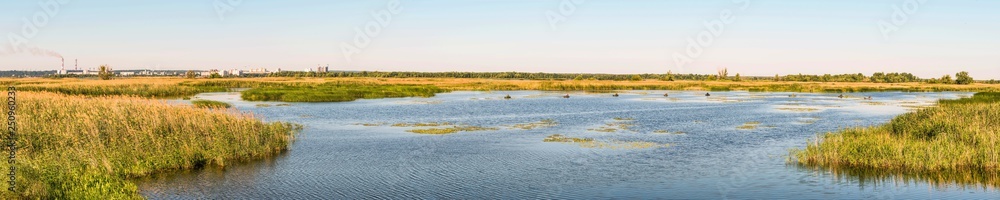 Panorama of the Dnieper River Bay. Fishing fishing in small boats. In the background is a fragment of the city of Ukrainka, Kiev region, Ukraine.
