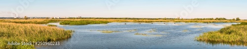 Panorama of the Dnieper River Bay. Fishing fishing in small boats. In the background is a fragment of the city of Ukrainka, Kiev region, Ukraine.