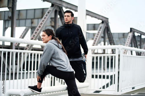 Young people exercising on bridge 