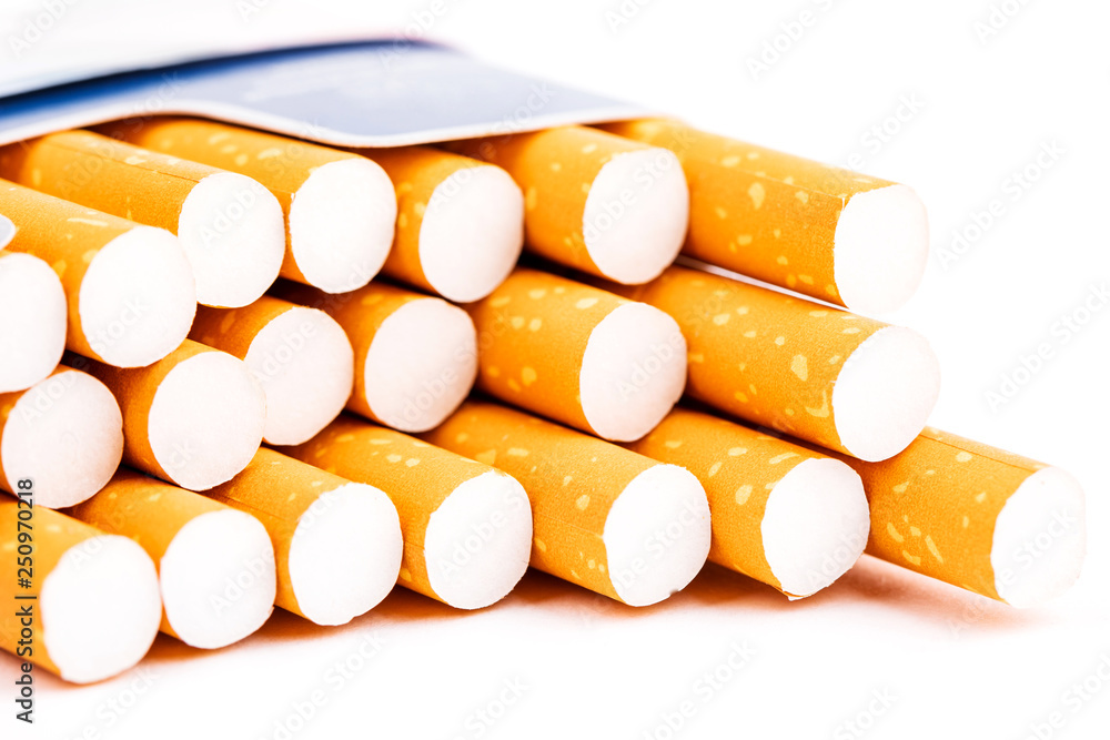 Cigarettes in a pack closeup on white background. Smoking tobacco. Bad habit. Cigarettes in a pack closeup on white background. Smoking tobacco. Bad habit.