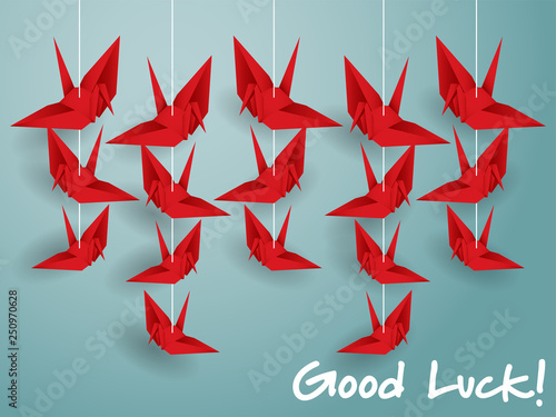 Hanging origami paper cranes in red color.