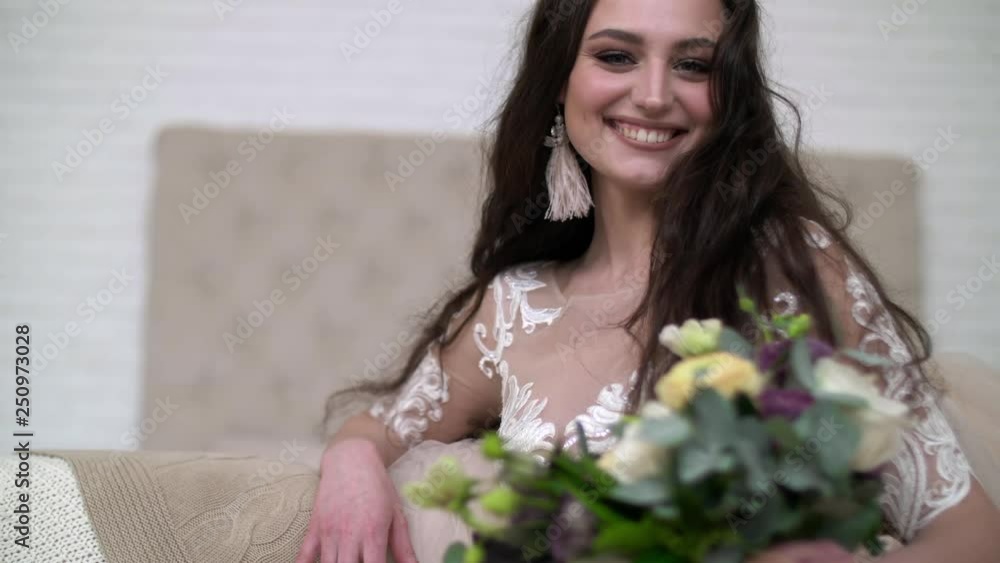 Portrait of a bride in wedding dress. Elegant brunette bride with flowers Portrait of a bride in wedding dress. Elegant brunette bride with flowers