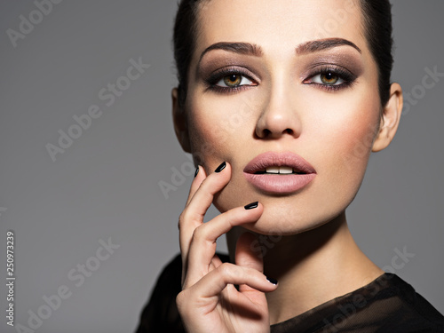 Photos Face of a beautiful girl with fashion makeup and black nails