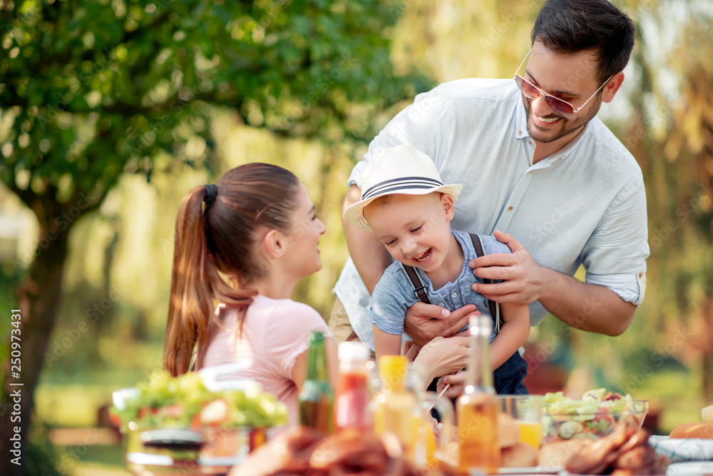 Obraz premium Happy family having a barbecue