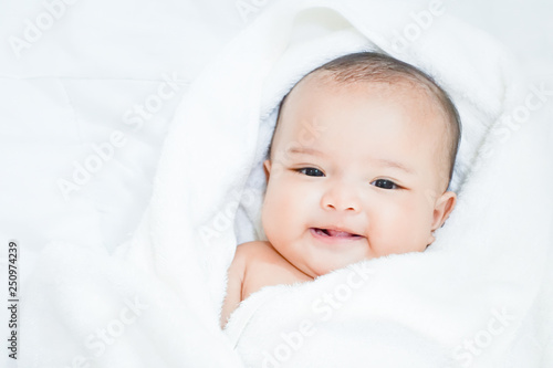 Asian baby girl under white towel after done shower