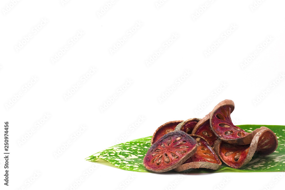 Fototapeta premium Dried slice Bale fruit with hard skin decorated with green plant leave on white background