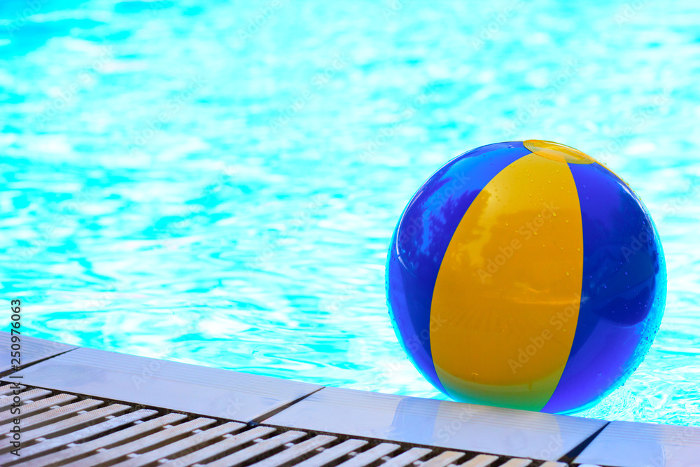 Blue yellow inflatable ball in the swimming pool